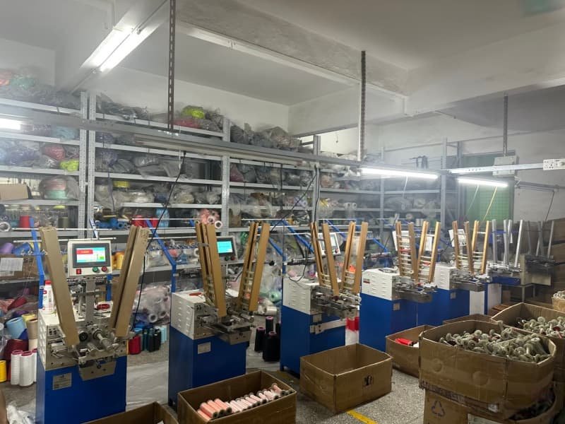 Automated yarn winding machines with raw materials in storage area