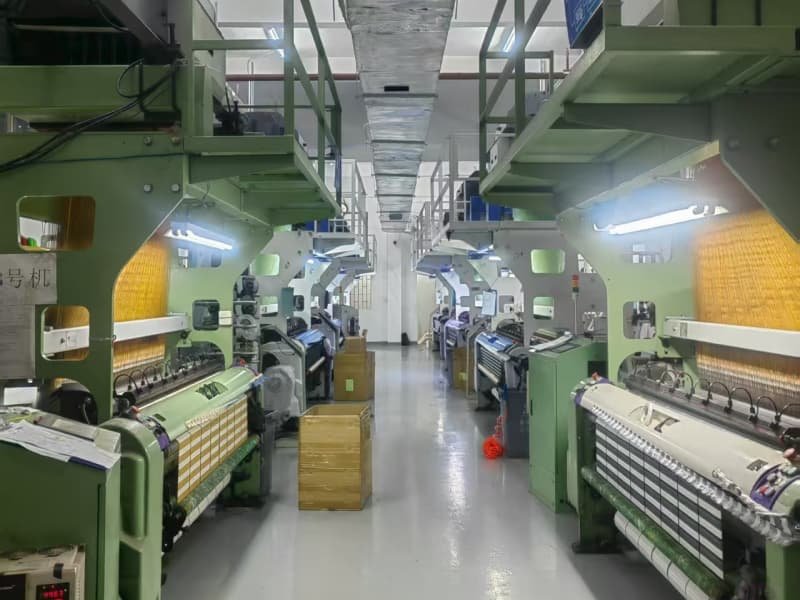 Large scale factory workshop with advanced weaving machinery for production