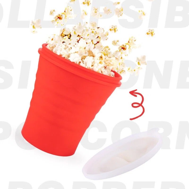 Red Silicone Popcorn Cup with popped popcorn spilling out