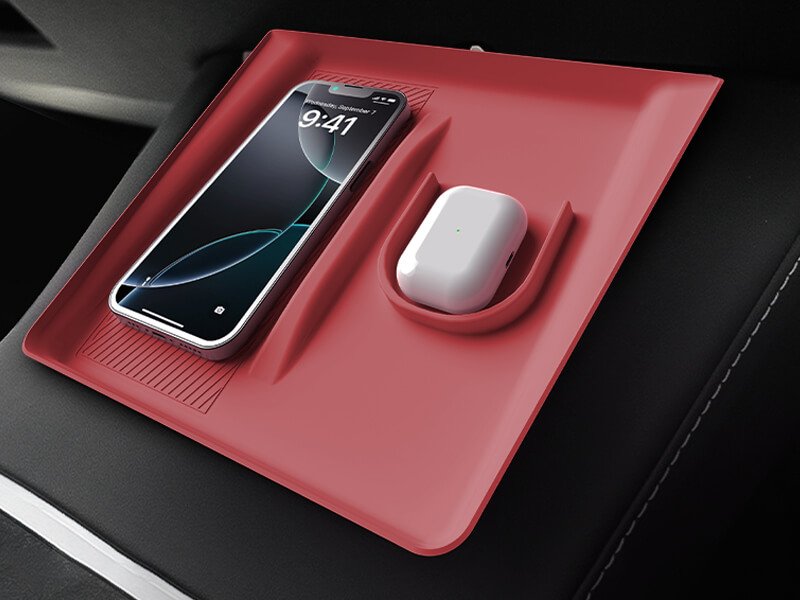 tesla-center-console-pad-red-phone-airpods-charging