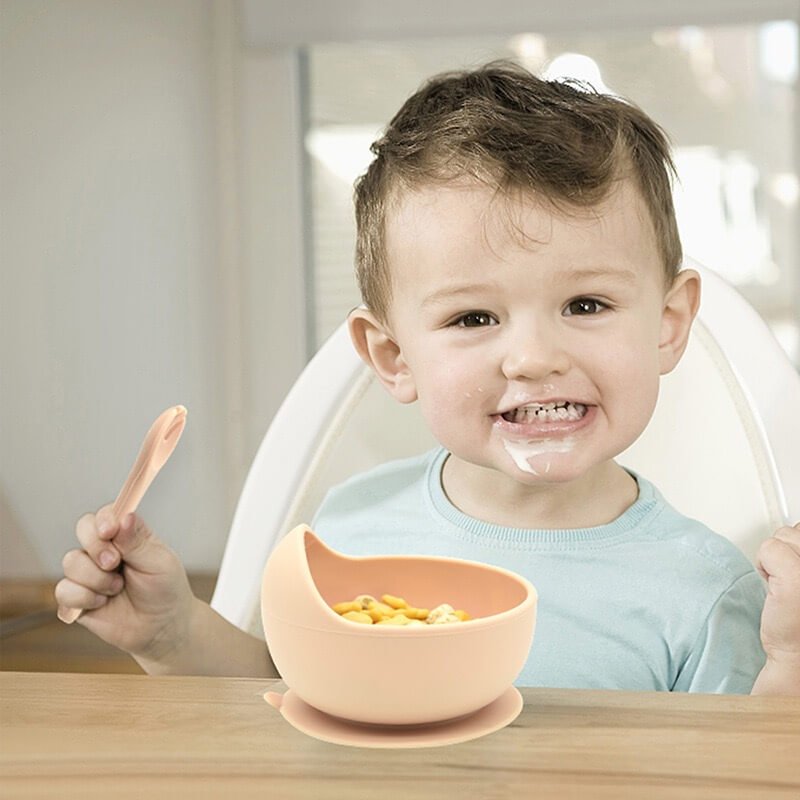 Toddler eating with silicone spoon and suction bowl
