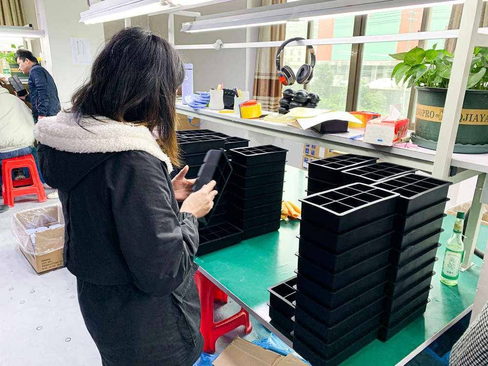 worker-inspecting-molded-silicone-trays-for-dimensional-and-surface-quality
